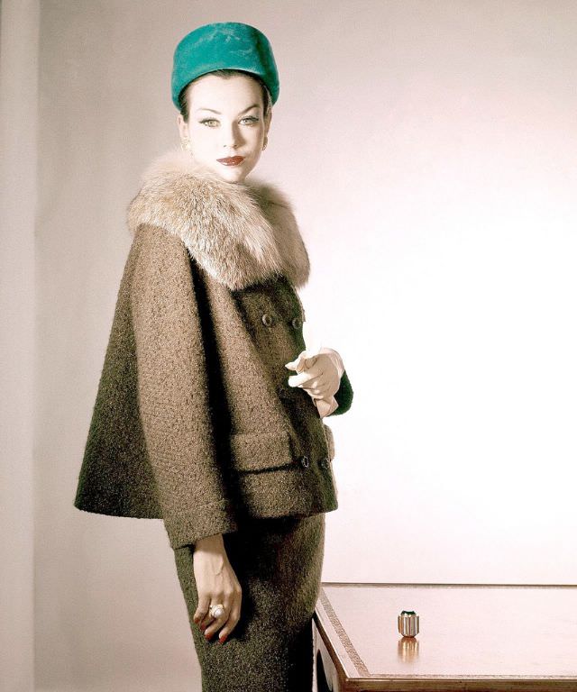 #37 Model in tobacco tweed suit with fur collar by Handelman & Raiffe and emerald green velvet pill box, Vogue, October 1, 1959