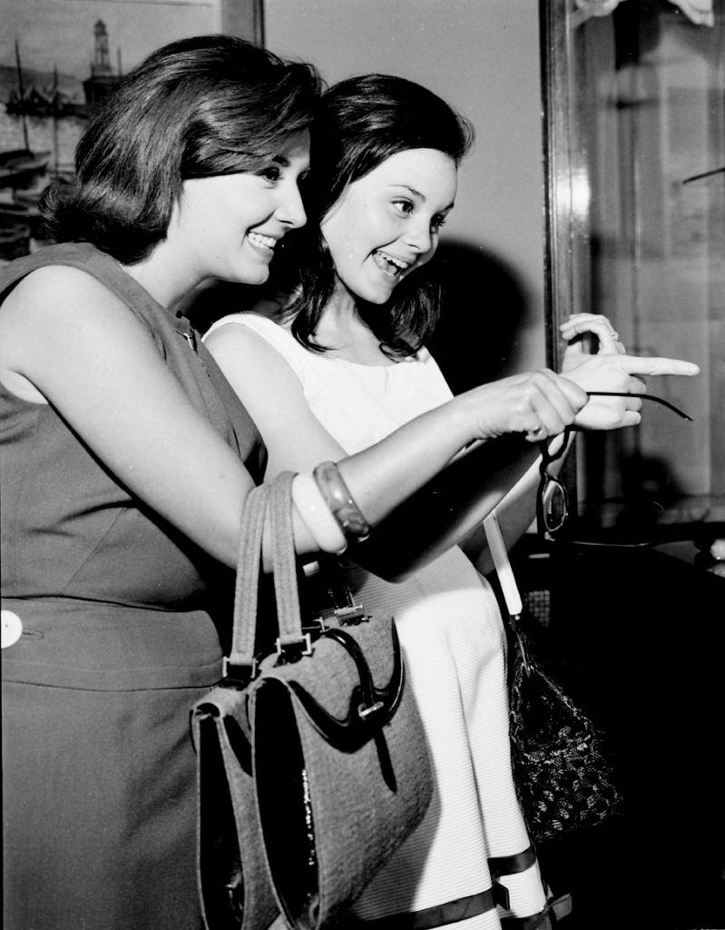 #22 The Spanish actress and singers Recio Durcal (R) and Concha Velasco walking in Barcelona, 1961,