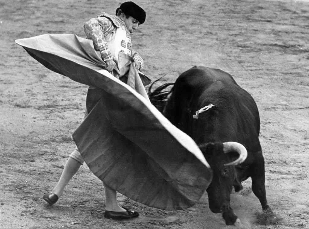 #29 Rafael Martin fighting with the Capa (the wide red cloak), Barcelona, 1960s.