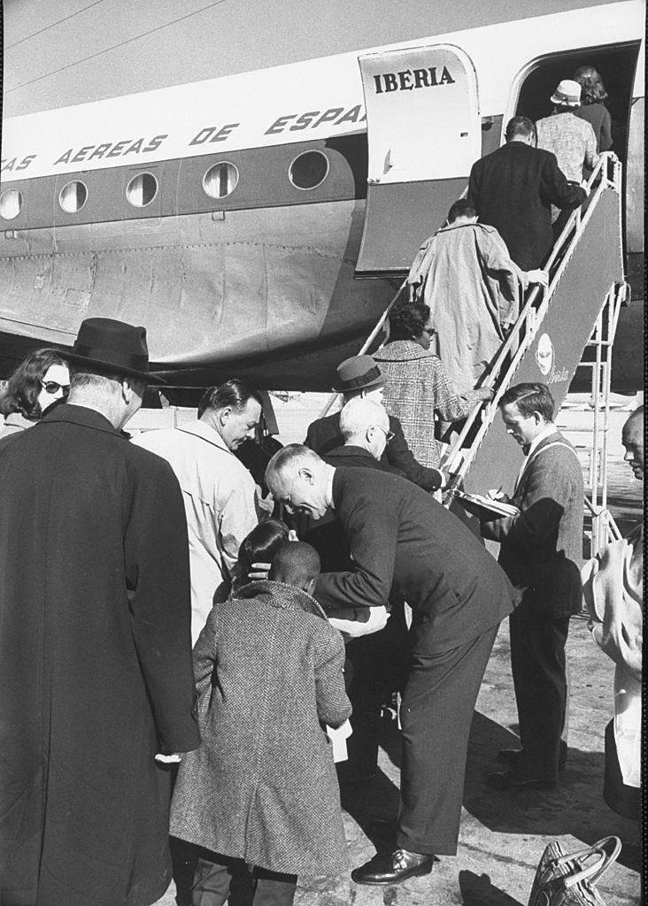 #45 Members of touring Theater Guild American Repertory Co. boarding plane for engagement in Barcelona, 1960.