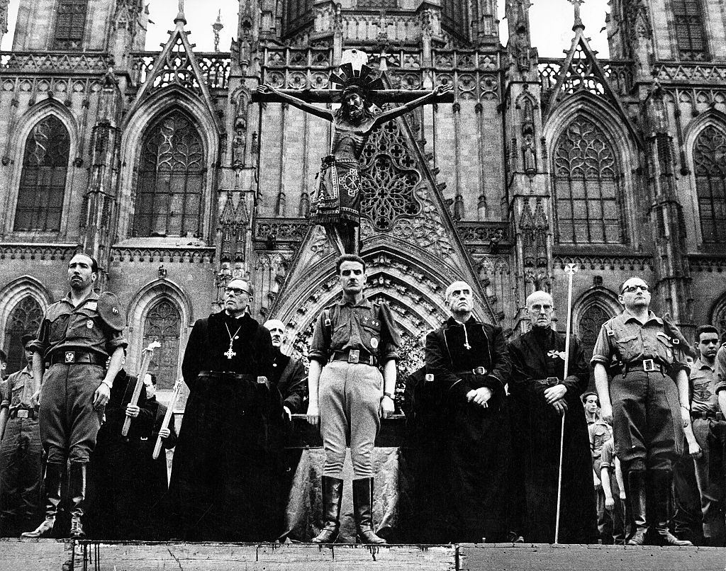 #55 Clerics and soldiers in front of the cathedral Santa Eularia, Barcelona 1962.