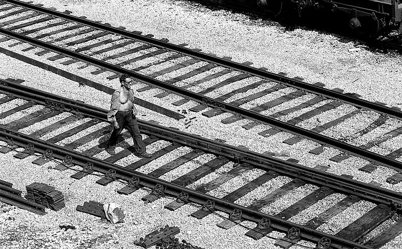 #6 A man passing by the train tracks, in the Zona Franca near the cargo port of Barcelona, 1977.