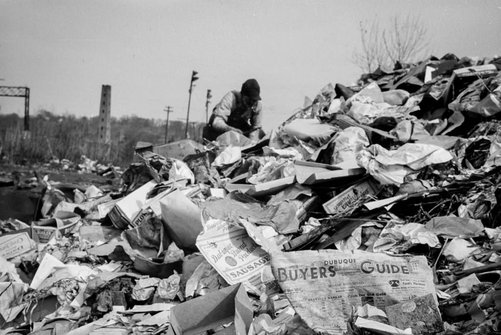 #5 A man scavenges in the Dubuque city dump.