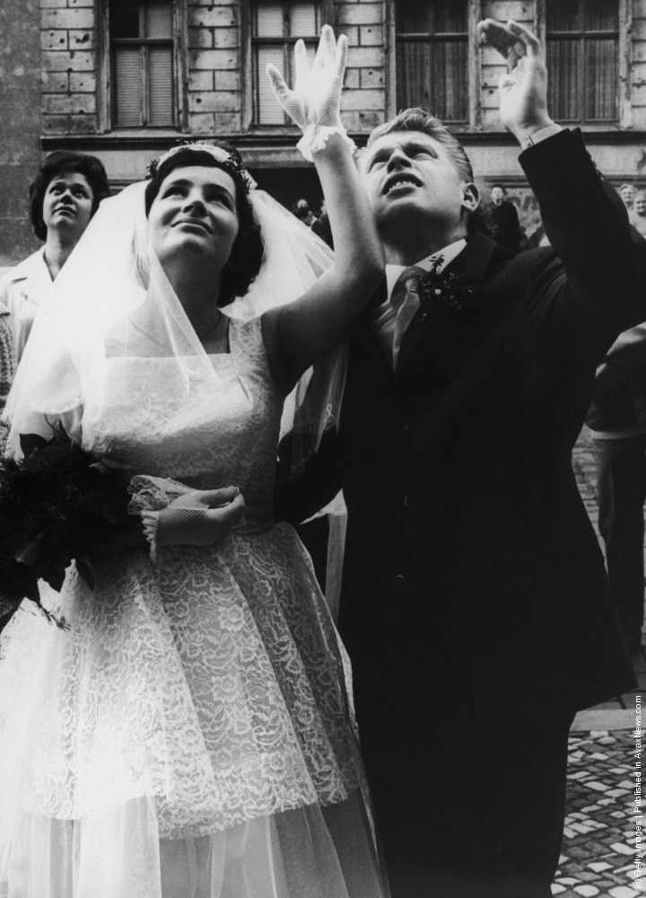 #112 Dieter and Monika Marotz of Bernauerstrasse, Berlin, wave to relatives after their wedding, 8th September 1961.