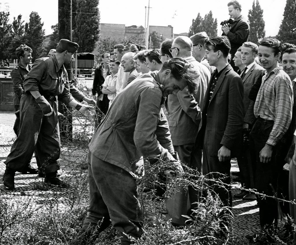 #5 East German soldiers, left, set up barbed wire barricades August , 13, 1961.