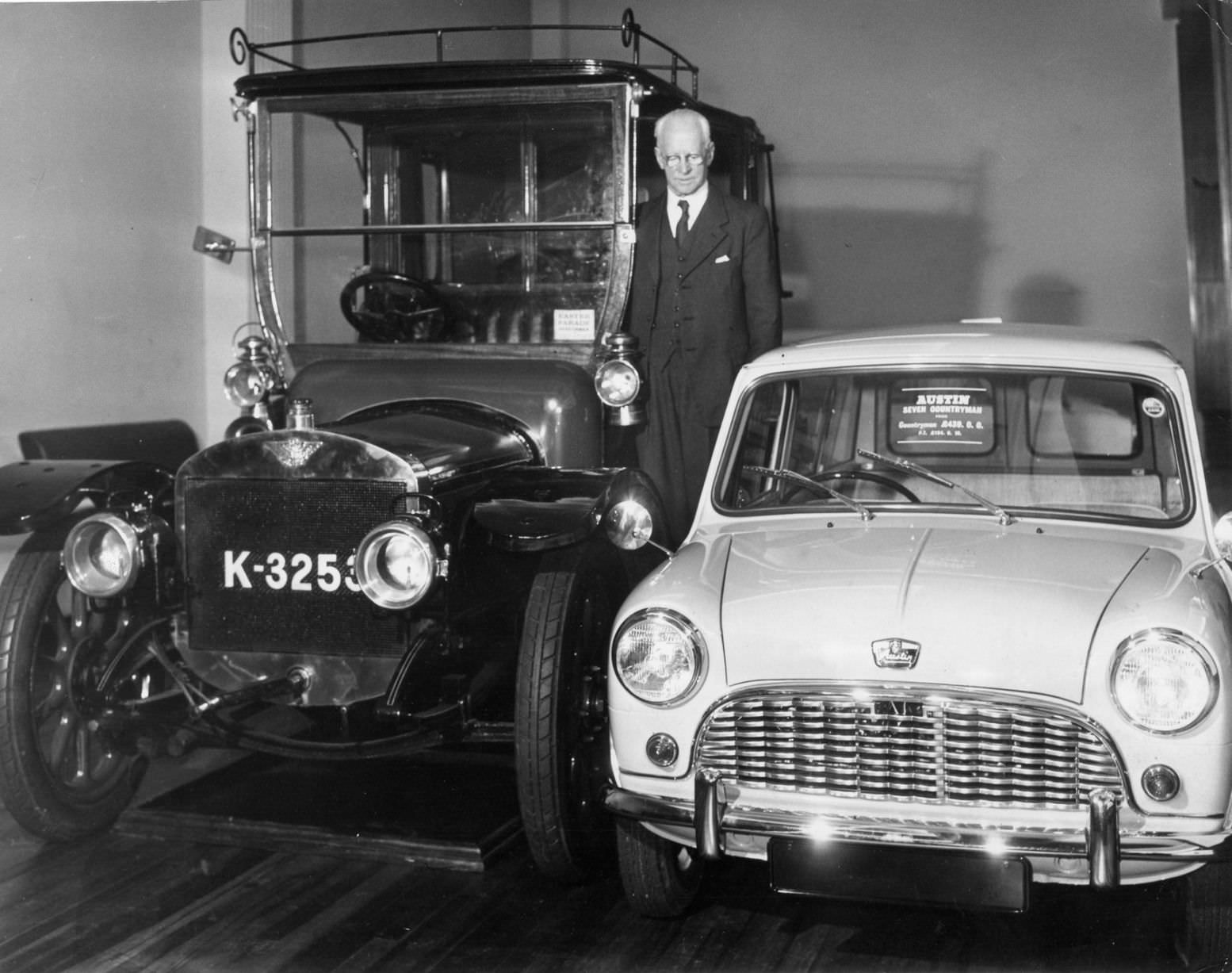 #33 Mr Norwood at Austin Motors with an old car and an Austin Seven Countryman, Birmingham, circa 1960.