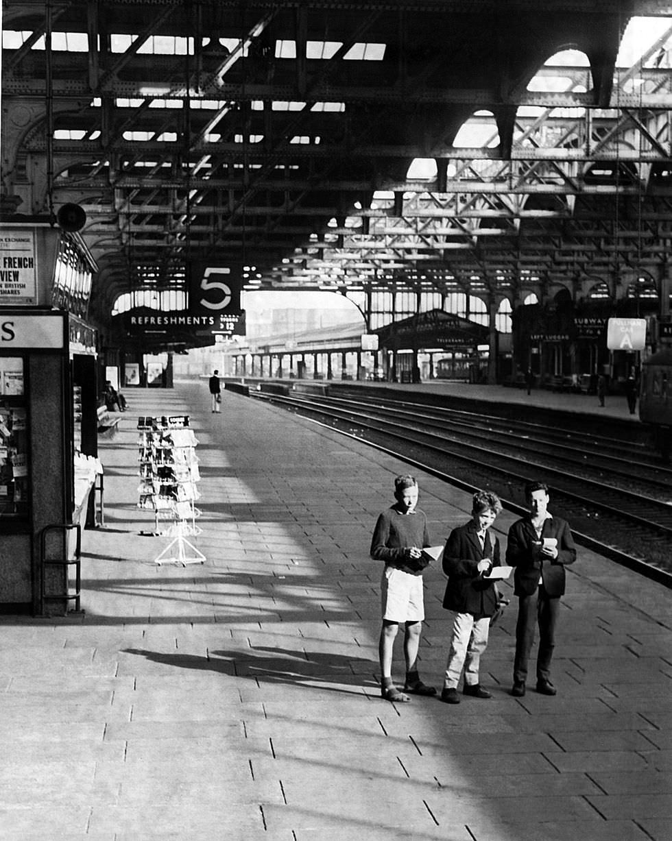 #36 Three young train spotters at a deserted Snow Hill railway station in Birmingham on a bank holiday Monday in 1962.