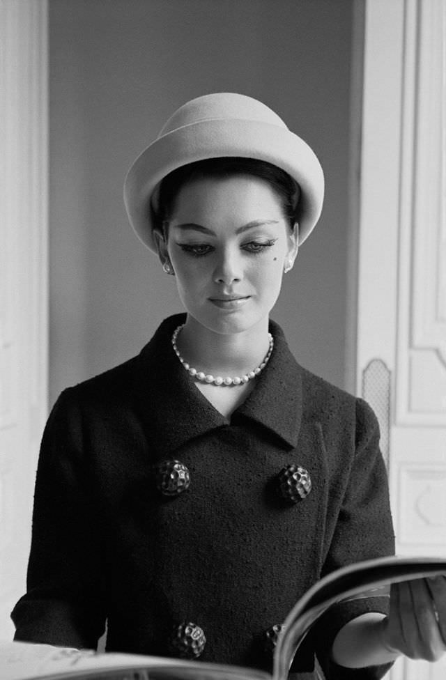 #19 Model in elegant bouclé suit by Givenchy at Givenchy’s salon, Paris, June 1960