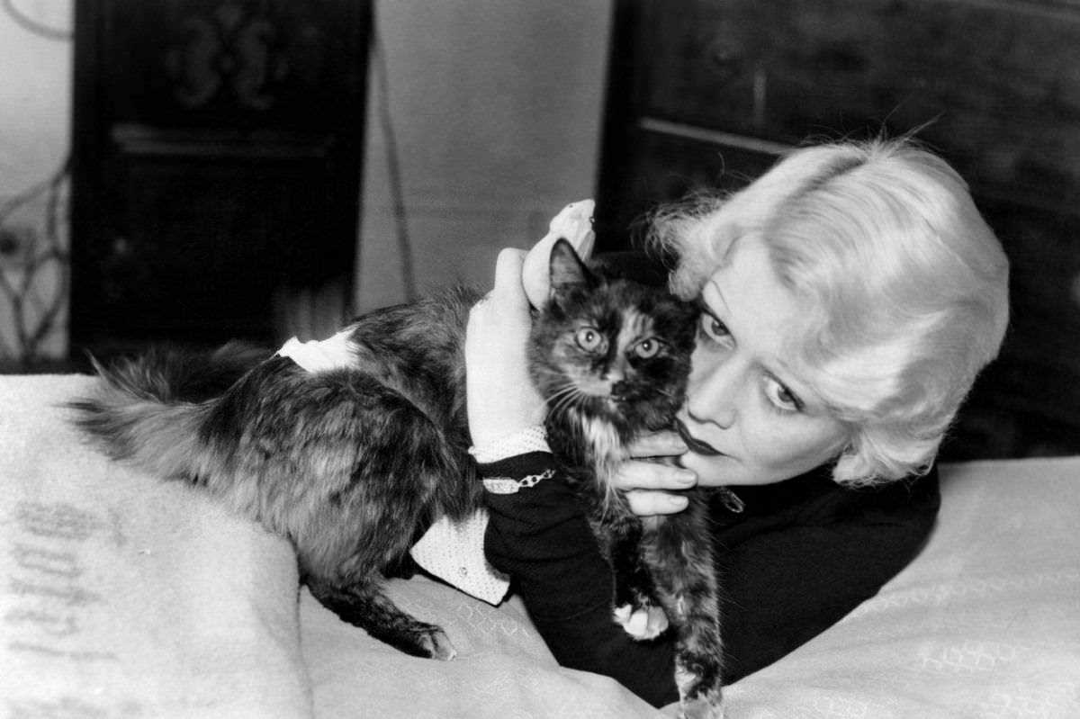 #2 The Maltese Falcon actress Gladys George hugs her tortoiseshell cat, whom she named Monkie.