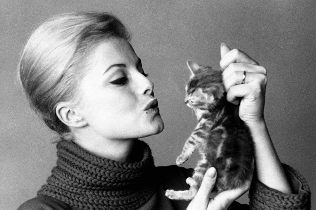#20 Italian actress Virna Lisi pretended to kiss a kitten, 1961.