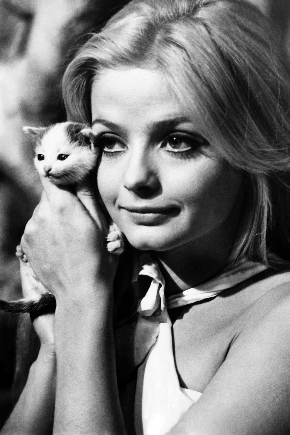 #26 The Swedish actress Ewa Aulin posed with a minuscule feline named Hurricane in July 1968.