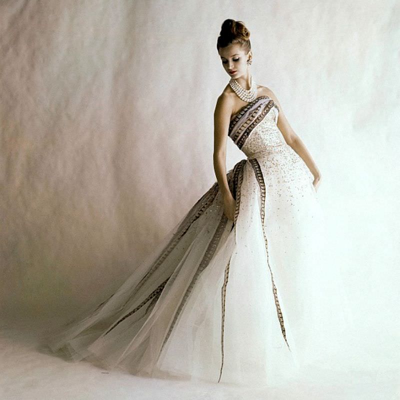 #11 Anna Carin Bjorck in a strapless ball gown made of white tulle with gold pailletes and pheasant feather ribbons by Balmain, June 1960
