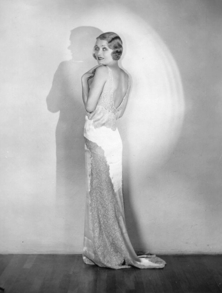 #37 Constance Bennett modelling a slinky backless evening dress, 1936.