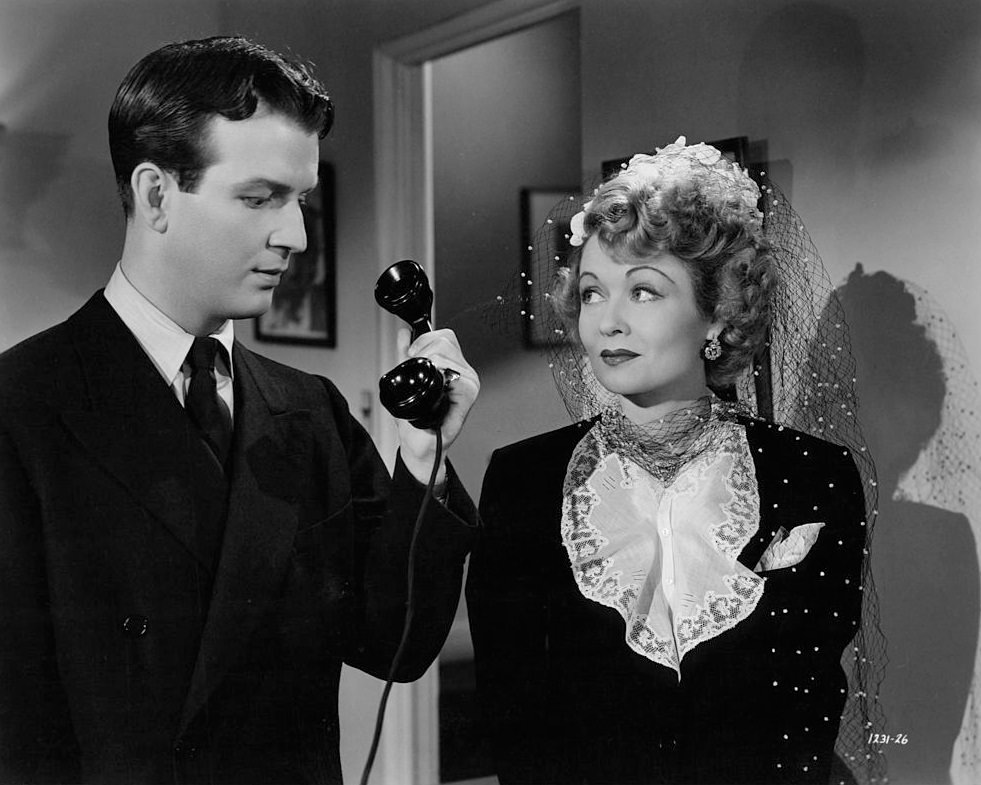 #56 Constance Bennett with Don Porter in a scene from the film ‘Madam Spy’, 1942.