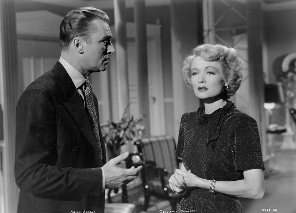 #58 Brian Aherne talking with Constance Bennett in a scene from the film ‘Smart Woman’, 1948.