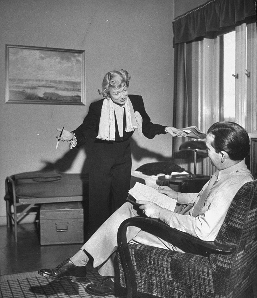 #61 Constance Bennett reading lines with a fellow actor, 1949.
