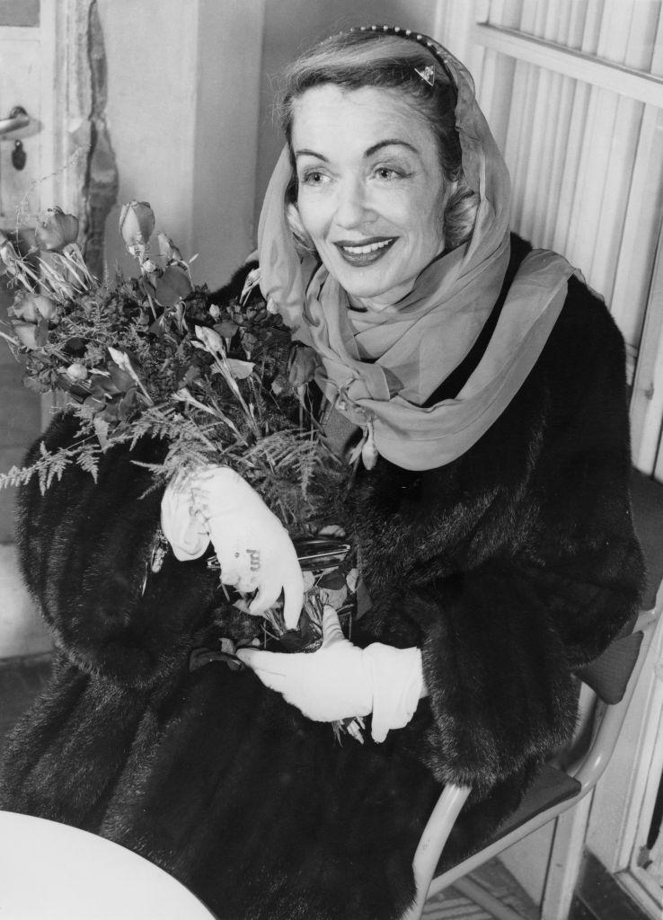 #64 Constance Bennett after her arrival in London, 30th January 1957.