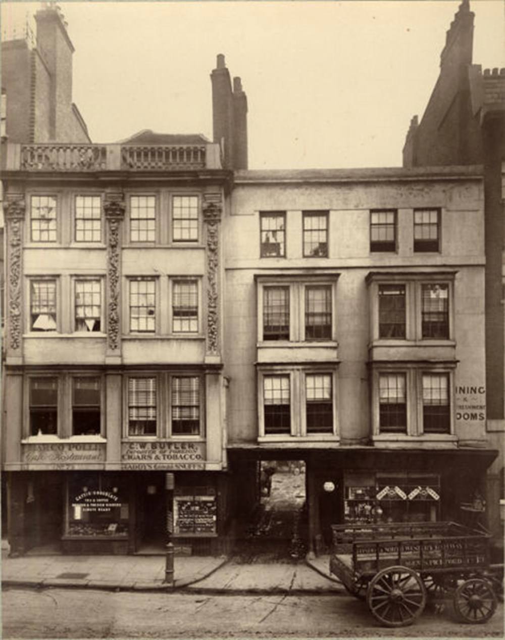#18 A woman lingers in front of the butcher in Borough High St, Southwark.