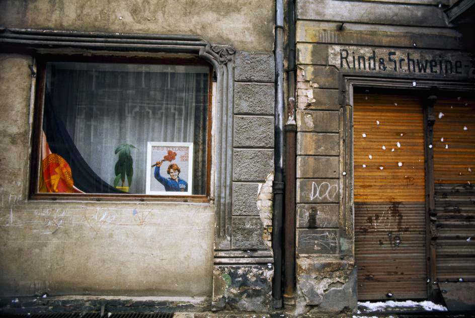 #18 Store window with GDR flag in the district of Prenzlauer Berg. East Berlin, 1974.