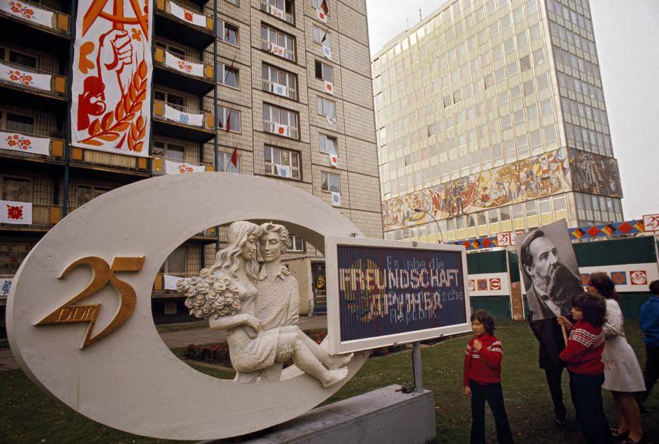 #21 Celebrating 25 years of the GDR on the Karl-Marx-Allee. East Berlin, 1974.