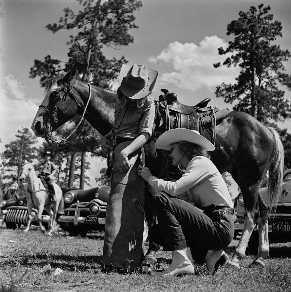 #12 A woman helps a young contestant at a youth rodeo in Houston, Texas, 29th May 1952.