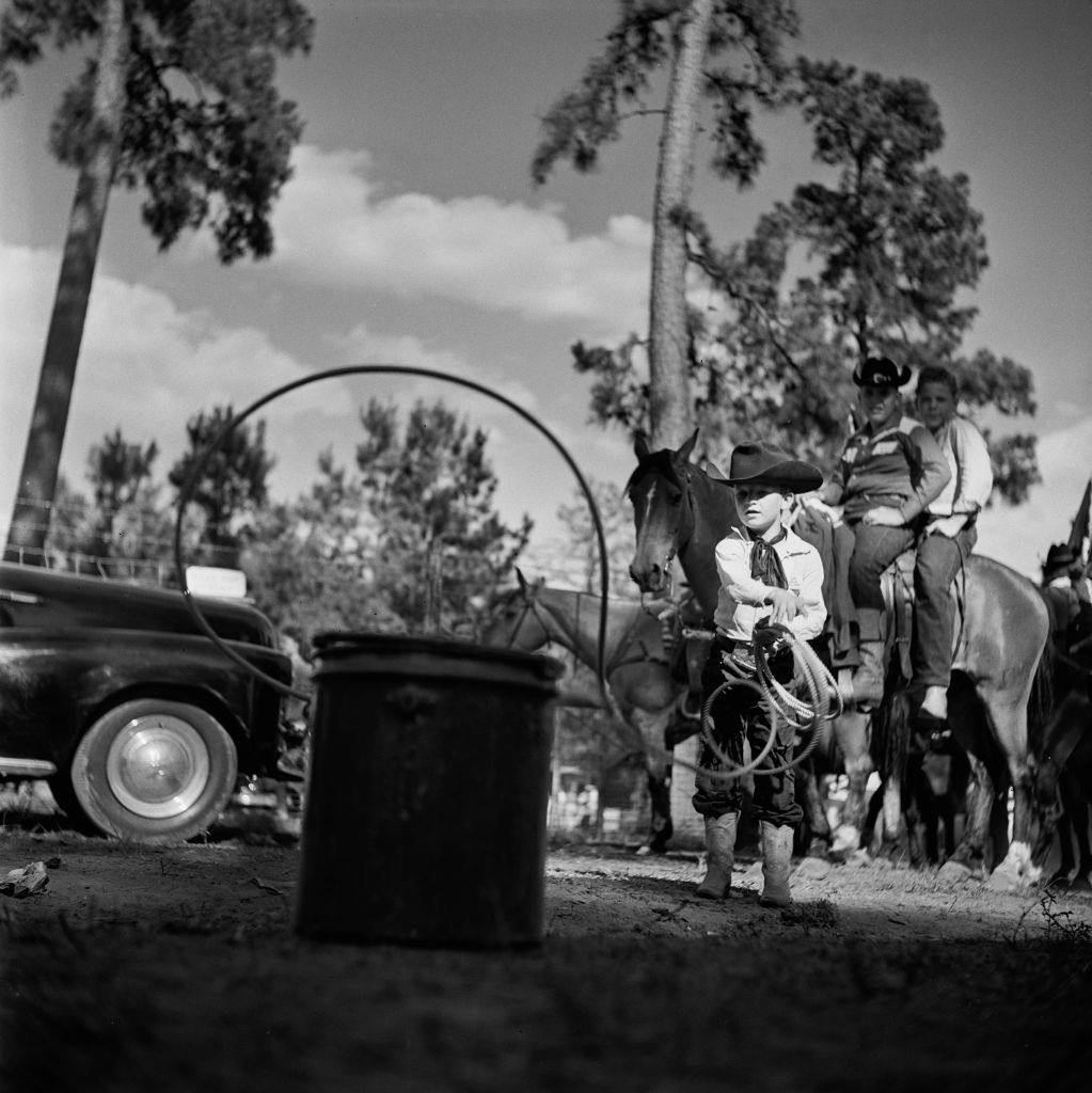 #53 A young contestant practising with the lasso at a youth rodeo in Houston, Texas, 29th May 1952.