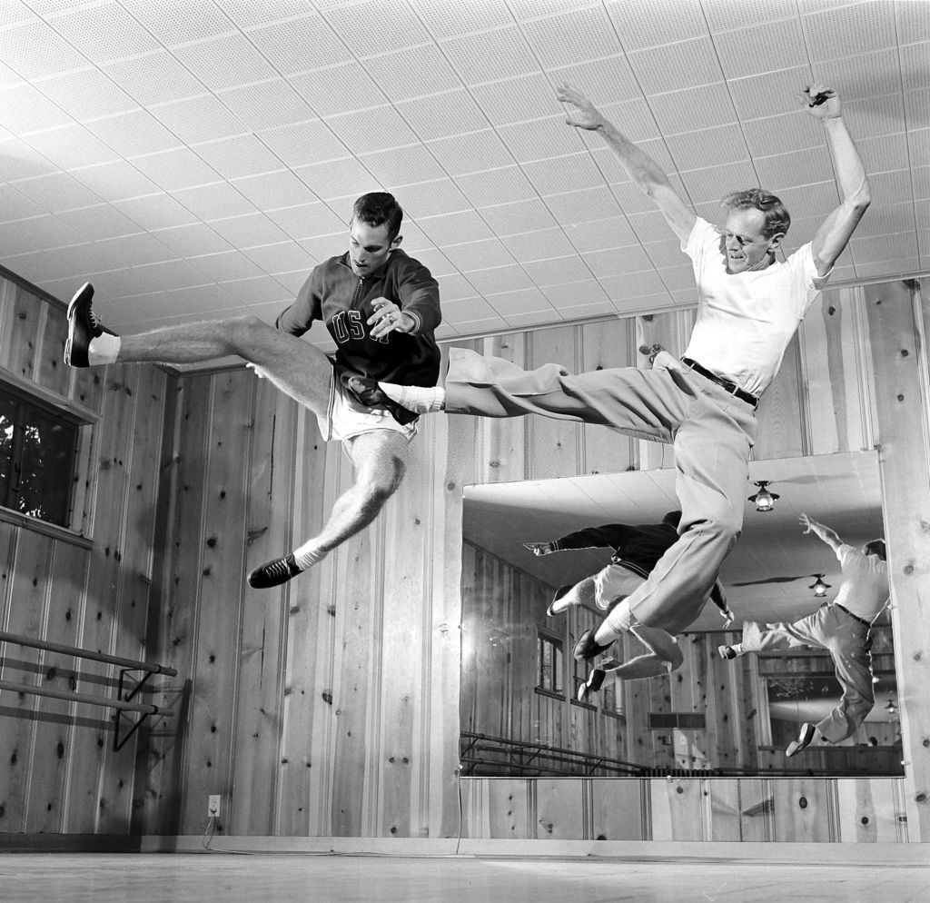 #29 Walt Davis with a man jumping on a ballet school, Houston, 1956.