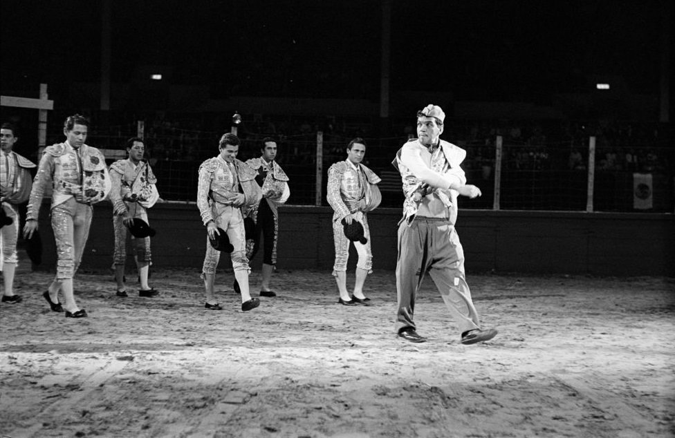 #3 Comedian Mario Moreno walking with men, Houston, 1952.