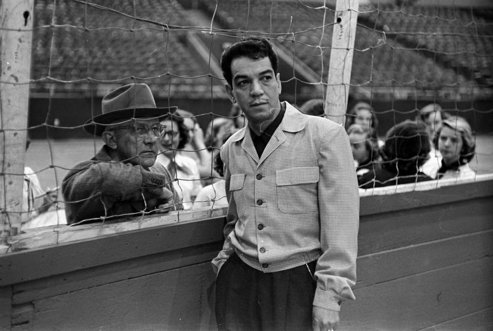 #7 Comedian Mario Moreno standing on fence, Houston, 1952.
