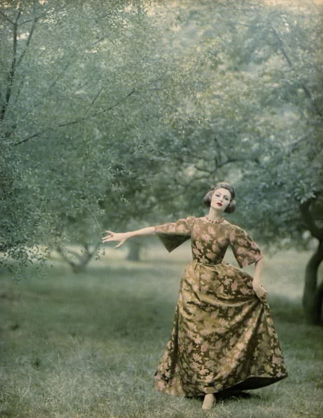 #18 Isabella Albonico in brocade gown of gold and pink flowers on green background shot with gilt Lurex by Branell, coiffure by Elizabeth Arden. Harper’s Bazaar, October 1959