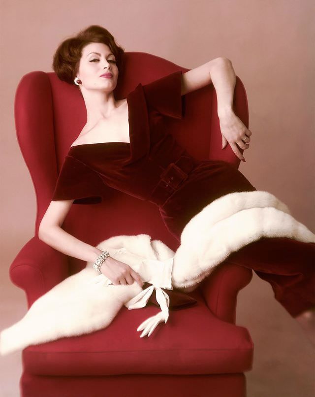 #26 Isabella Albonico photographed by John Rawlings, wearing burgundy velvet dress by Harvey Berin with white mutation mink stole by Saga, 1959
