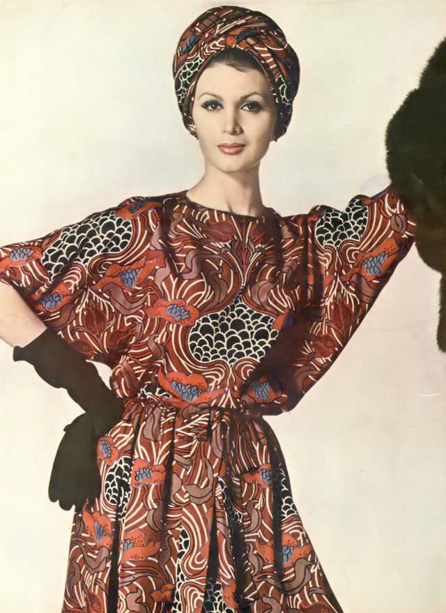 #43 Isabella in silk dress printed in swirls of pale brown and wine with lotus tendrils. Vogue, June 1, 1960