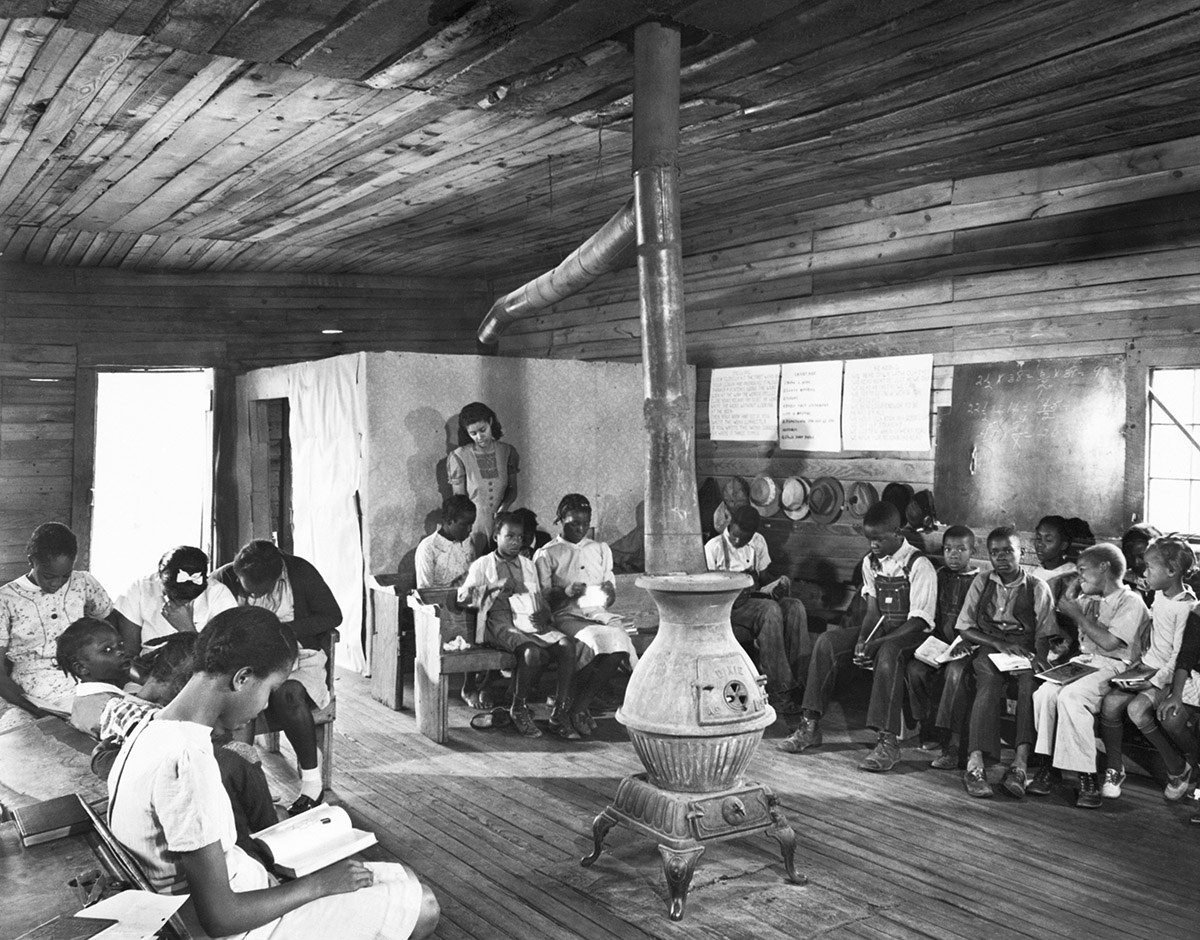 #23 A teacher instructs a segregated class of black students at a poorly funded, one-room school in the backwoods of Georgia in 1941.