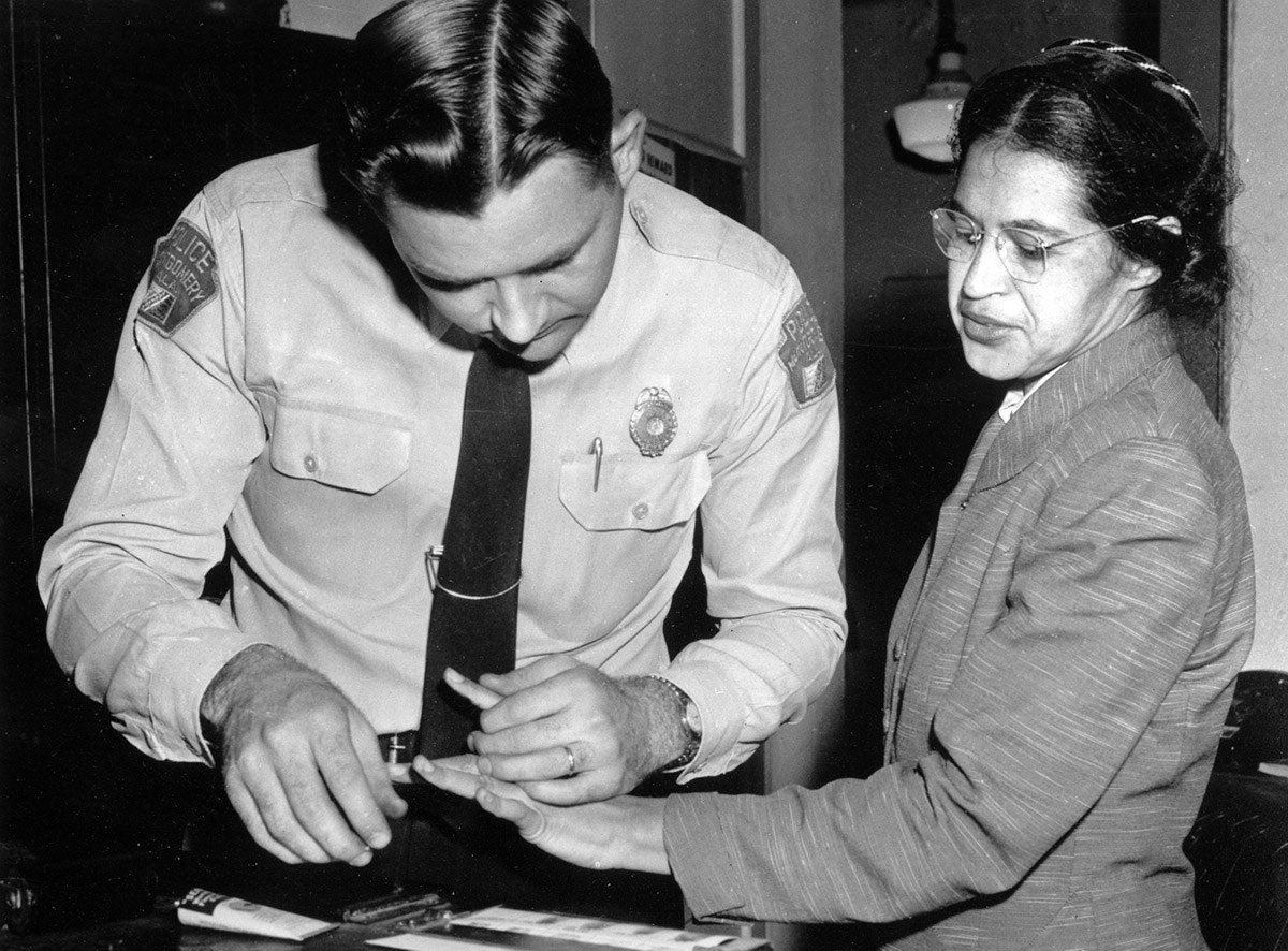 #27 Rosa Parks is fingerprinted by a police officer in Montgomery, Alabama, on Feb. 22, 1956, two months after refusing to give up her seat on a bus for a white passenger on Dec. 1, 1955.