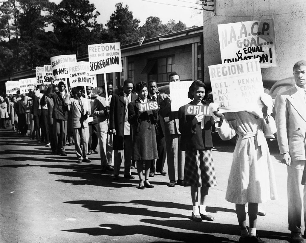 #37 A line of African Americans hailing from states across the USA march to protest segregation. Ca. 1950.