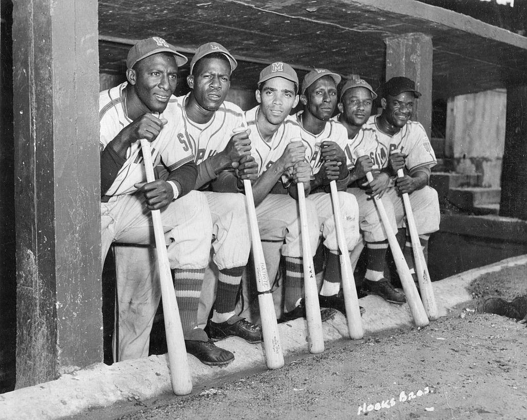 #38 A group of Cuban baseball players from the Negro League Red Sox in the dugout together during a home game, Memphis, Tennessee, circa 1951.