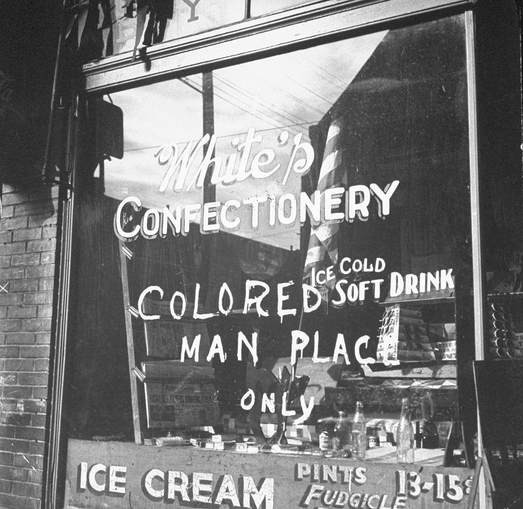#61 Shop window with words “colored man place only”, 1943.