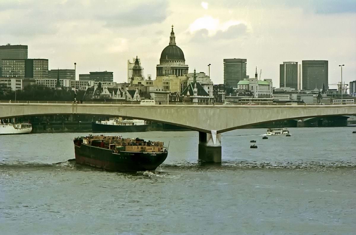 #26 A barge passes beneath Waterloo Bridge on 19th April 1975