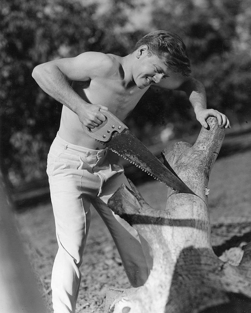 #13 Mickey Rooney cutting a wood, 1930s.