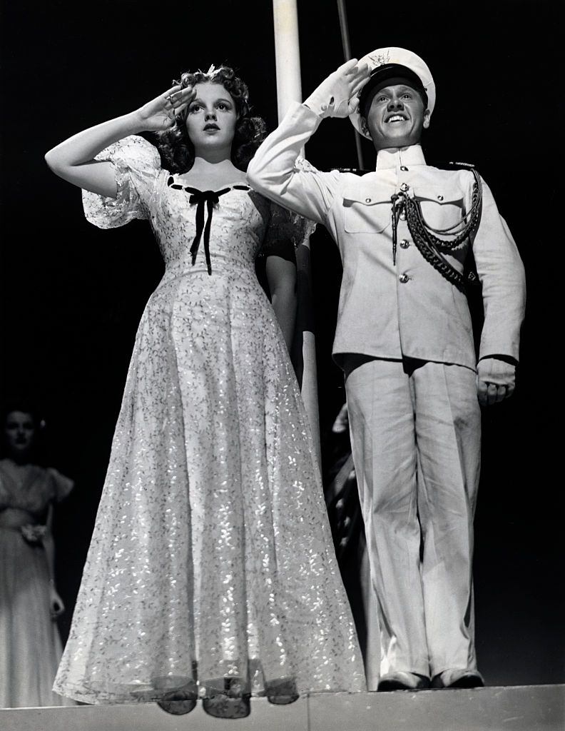#21 Mickey Rooney and Judy Garland saluting in the movie ‘Strike up the Band’, 1940s.