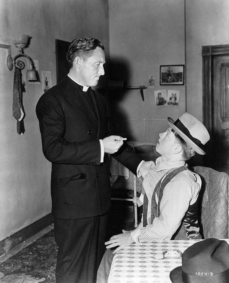 #41 Spencer Tracy disciplines Mickey Rooney for smoking in a scene from the film ‘Boys Town’, 1938.