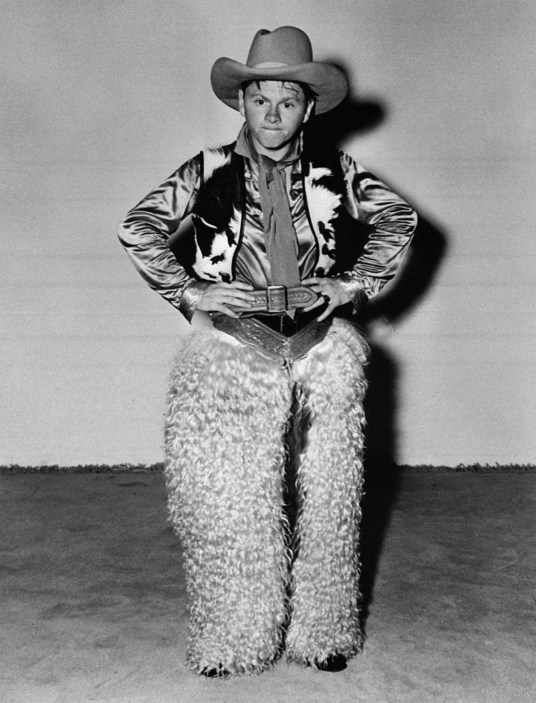#2 Mickey Ronney posing in a cowboy costume.
