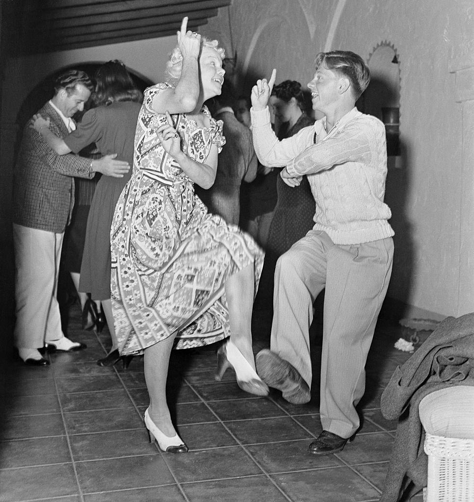 #49 Mickey Rooney Rescues Nancy Carroll, 1939.Mickey Rooney dancing with her mother at a party