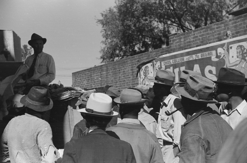 #14 Itinerant salesman selling goods from his truck to workers in center of town on Saturday afternoon. Belzoni, Mississippi Delta. November 1939