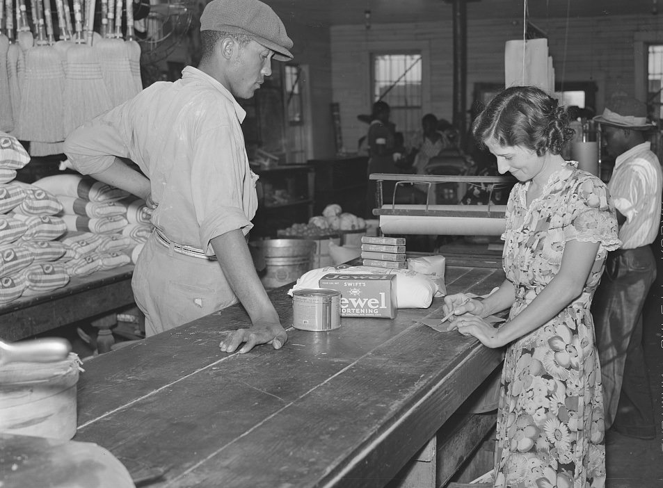 #17 Wagehand purchasing groceries after being paid off on Saturday in plantation store. Mileston Plantation. Mississippi Delta, November 1939