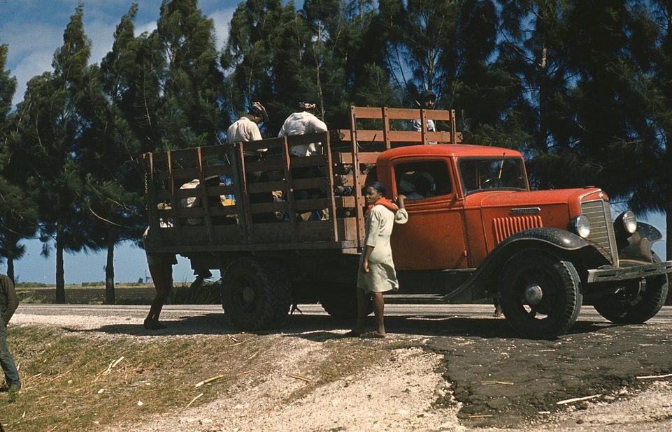 #19 Photograph shows a 1934-1936 International C30 truck transporting people who might be farm workers.