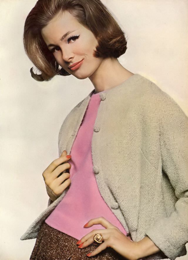#9 Monique Chevalier in cinnamon skirt and blond cardigan of wool tweed over pink sleeveless angora and lambswool pull-over, Vogue. August 1, 1961