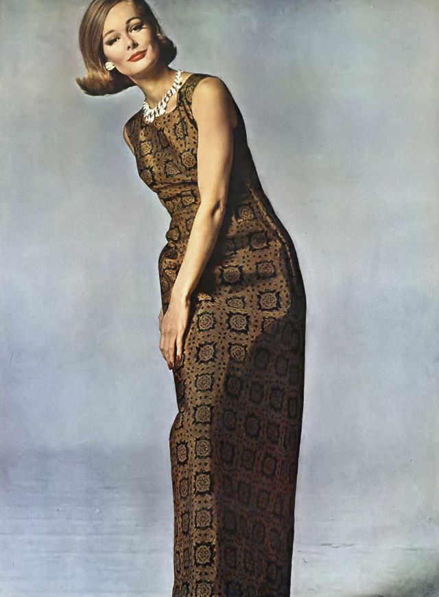 #18 Monique Chevalier in long sheath of bronze silk, tile-printed in black, Vogue. May 1, 1962