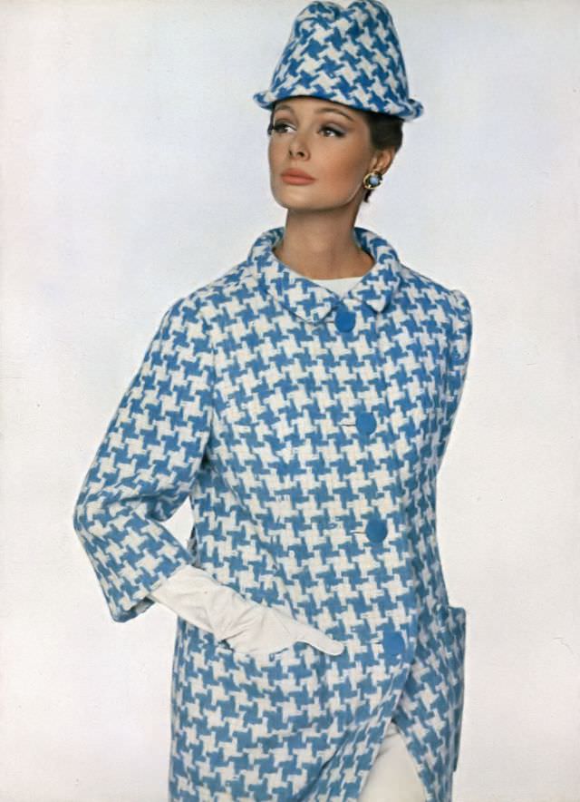 #26 Monique Chevalier in slim coat of blue and white wool houndstooth, Vogue. January 1, 1963