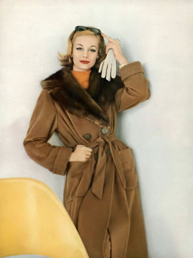 #33 Monique Chevalier in the end-all trenchcoat of vicuña and natural Russian sable, Vogue. September 15, 1958